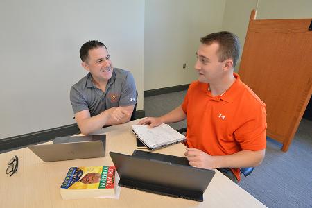 Maj. Jochen Arndt and Mitchell Masterson ’22 compare notes regarding Masterson’s independent research project on the media coverage out of South Africa in the early 1990’s.--VMI Photo by Mary Price.